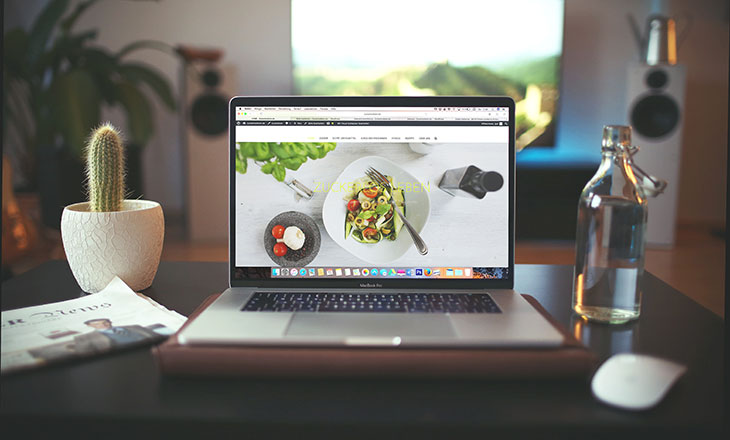 laptop on desktop displaying food website